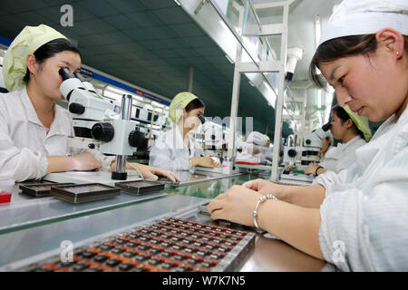--FILE--Female Chinese workers produce electric products on the assembly line at a factory in Huaibei city, east China's Anhui province, 21 September Stock Photo