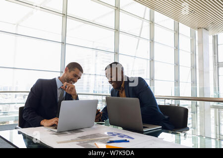 Two happy young businessmen in an office Stock Photo
