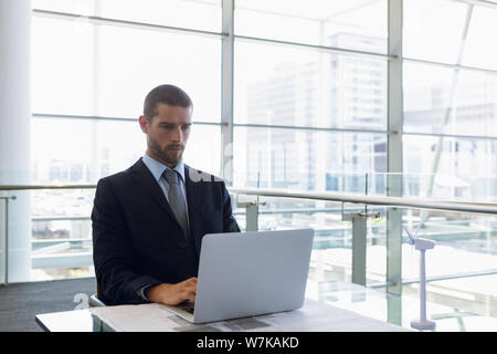 Businessman using laptop at work Stock Photo