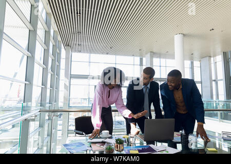 Three young business people working together Stock Photo
