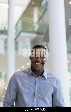 Smiling businessman in modern business building Stock Photo