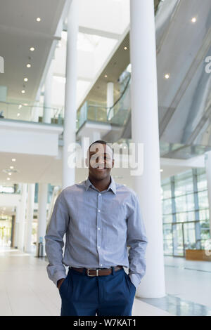 Smiling businessman in modern business building Stock Photo