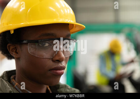 Female worker looking at camera in warehouse Stock Photo
