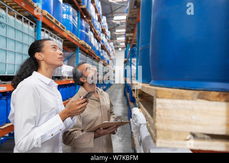 Female manager checking inventory in warehouse Stock Photo