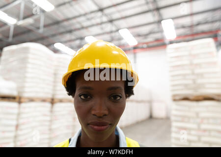 Female worker looking at camera in warehouse Stock Photo