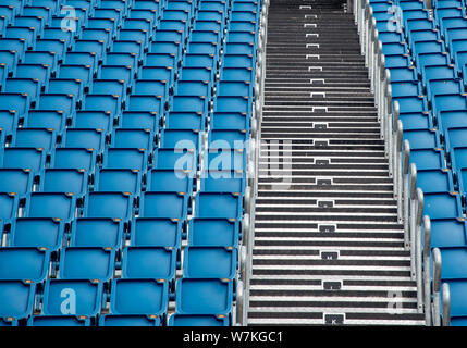 Blue plastic empty stadium or stage chairs in a row Stock Photo