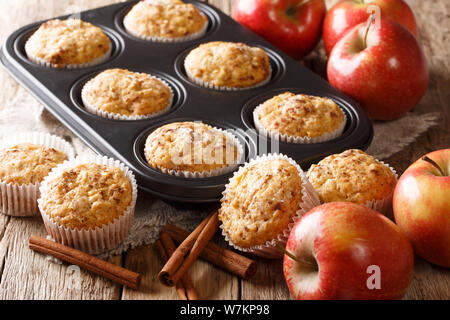 Sweet dessert apple muffins with cinnamon close-up in a baking dish on the table. horizontal Stock Photo