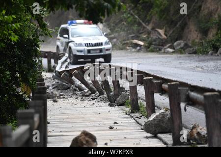 A road is damaged by rubbles from a landslide after the 7.0-magnitude earthquake in Jiuzhaigou County, Ngawa Tibetan and Qiang Autonomous Prefecture, Stock Photo