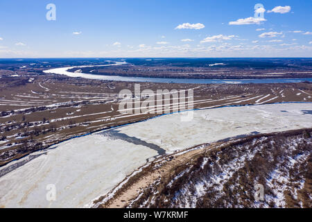 Flying drone over the ice floating on the river Oka, Russia Stock Photo