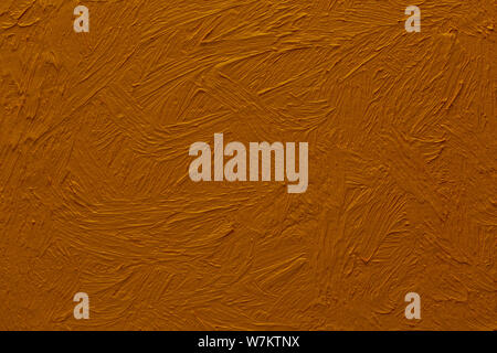 Abstract painted background. Background was painted with ochre brown oil color on canvas by hand. Stock Photo