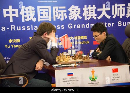 Chinese chess grandmaster Yu Yangyi, right, competes against Russian chess grandmaster Alexander Igorevich Grischuk during the 2017 China-Russian Ches Stock Photo