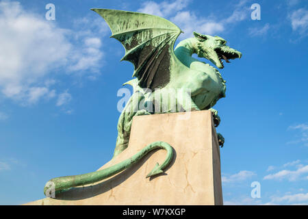 Dragon Bridge dragon statue on the Dragon bridge concrete plinth against a blue sky Zmajski most Ljubljana Slovenia Eu Europe Stock Photo