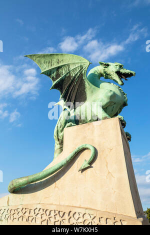Dragon Bridge dragon statue on the Dragon bridge concrete plinth against a blue sky Zmajski most Ljubljana Slovenia Eu Europe Stock Photo