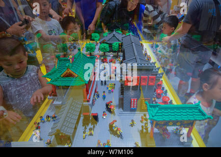 Visitors look at the LEGO sculpture of Guwenhua Jie, Tianjin's Ancient Culture Street, made of 30,000 LEGO bricks, at Tianjin's first LEGO Authorized Stock Photo