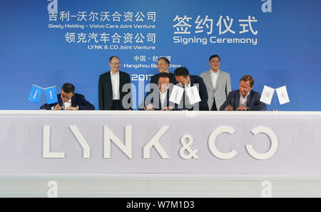 President An Conghui, front center, Chairman Li Shufu, back center, of Geely Holding Group, and Hakan Samuelsson, front right, of Volvo Cars Corporati Stock Photo