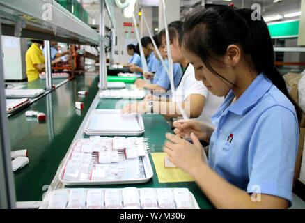--FILE--Female Chinese workers produce electronic products on the ...