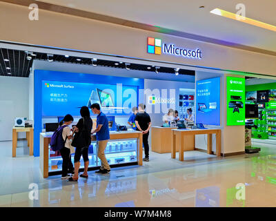 --FILE--Cusotmers visit a retail store of Microsoft in Guangzhou city, south China's Guangdong province, 25 June 2016.   Microsoft Corp has unveiled i Stock Photo