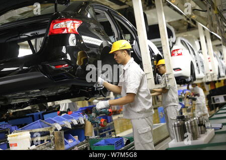 --FILE--Chinese workers assemble cars on the assembly line at the auto ...