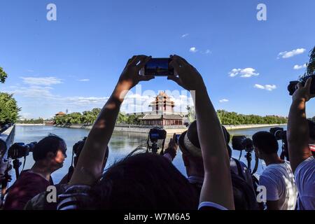 Photography enthusiasts take pictures of the Turret at the Palace Museum, also known as the Forbidden City, on a clear day in Beijing, China, 6 August Stock Photo