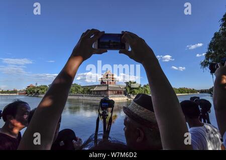 Photography enthusiasts take pictures of the Turret at the Palace Museum, also known as the Forbidden City, on a clear day in Beijing, China, 6 August Stock Photo