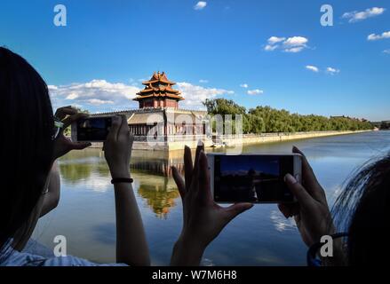 Photography enthusiasts take pictures of the Turret at the Palace Museum, also known as the Forbidden City, on a clear day in Beijing, China, 6 August Stock Photo