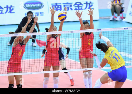 (From left) Gong Xiangyu, Gao Yi and Zhu Ting of China jump to block a spike by Tandara Caixeta of Brazil during their match of the FIVB Volleyball Wo Stock Photo