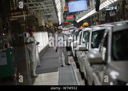 --FILE--Chinese workers assemble cars on the assembly line at the auto ...