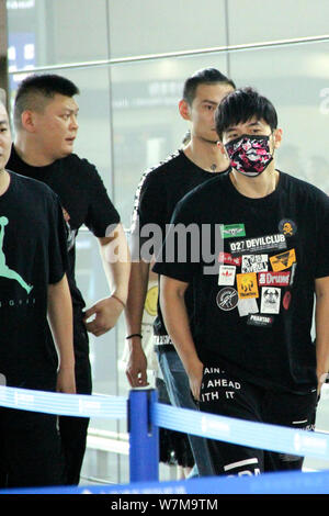 Taiwanese singer Jay Chou, right, is pictured at the Shanghai Hongqiao International Airport in Shanghai, China, 17 August 2017. Stock Photo