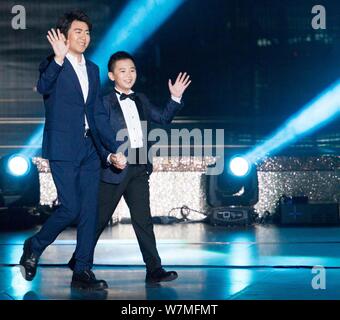 Chinese pianist Lang Lang, left, performs during a grand variety show as part of the events celebrating the 20th anniversary of Hong Kong's return to Stock Photo