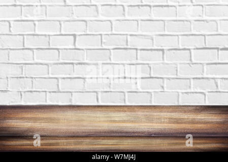 Wooden Shelf or Table in front of clean empty white brick Wall with space for Text or Ideas Stock Photo