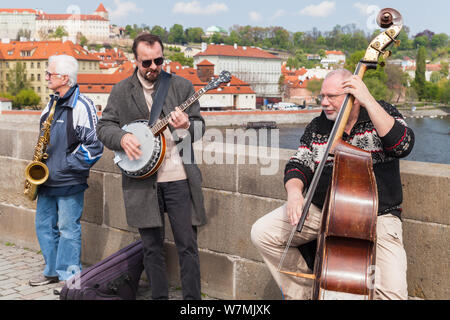 Prague, Czech Republic - April 30, 2017: Street musicians perform for tourists on the Charles Bridge in Prague Stock Photo