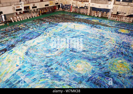 A huge collage showing a rendition of Vincent Van Gogh's masterpiece The Starry Night created by nearly 10,000 children is on display at an art festiv Stock Photo