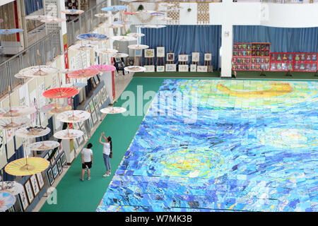 A huge collage showing a rendition of Vincent Van Gogh's masterpiece The Starry Night created by nearly 10,000 children is on display at an art festiv Stock Photo