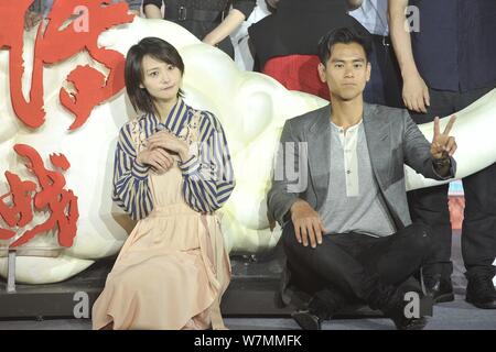 Chinese actress Zheng Shuang, left, and Taiwanese actor Eddie Peng attend a press conference for the premiere of the new movie 'Wu Kong' in Beijing, C Stock Photo