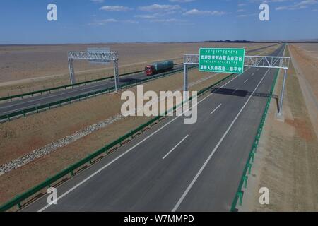 Aerial view of the Beijing-Urumqi Expressway, commonly known as the Jingxin Expressway, through the Gobi desert in Jiuquan city, northwest China's Gan Stock Photo