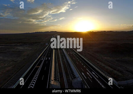 Aerial view of the Beijing-Urumqi Expressway, commonly known as the Jingxin Expressway, through the Gobi desert in Jiuquan city, northwest China's Gan Stock Photo