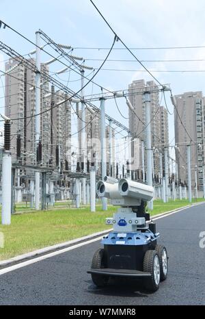 A robot is pictured as it is used to help Chinese workers check the substation during the scorching days at a power transformer substation in Chuzhou Stock Photo