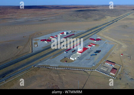 Aerial view of the Beijing-Urumqi Expressway, commonly known as the Jingxin Expressway, through the Gobi desert in Jiuquan city, northwest China's Gan Stock Photo