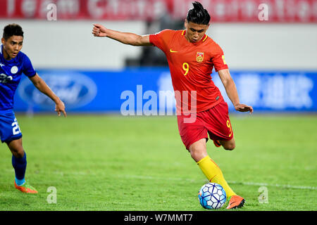 Zhang Yuning of Chinese national men's football team shoots against the Philippines during a friendly match in Guangzhou city, south China's Guangdong Stock Photo