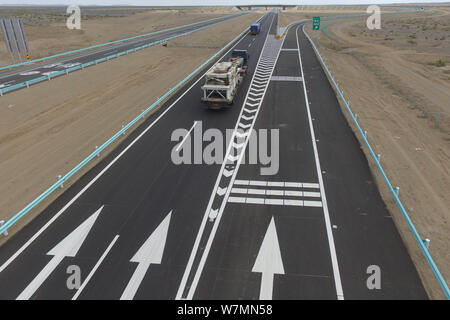 Aerial view of the Beijing-Urumqi Expressway, commonly known as the Jingxin Expressway, through the Gobi desert in Jiuquan city, northwest China's Gan Stock Photo