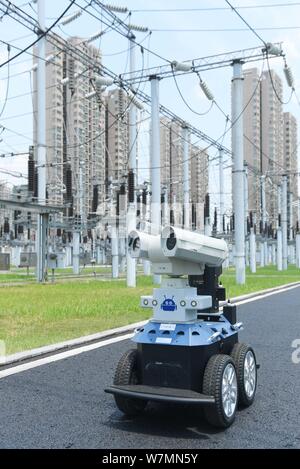 A robot is pictured as it is used to help Chinese workers check the substation during the scorching days at a power transformer substation in Chuzhou Stock Photo