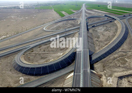 Aerial view of the Beijing-Urumqi Expressway, commonly known as the Jingxin Expressway, through the Gobi desert in Jiuquan city, northwest China's Gan Stock Photo