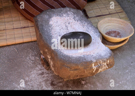 Smooth flat stone and round black stone used to grind maize at Lesedi Cultural Village, Cradle of Humankind, South Africa Stock Photo