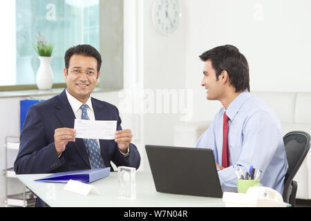 Customer showing bank loan cheque Stock Photo