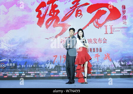 Chinese actress Yang Mi, right, and Taiwanese actor Chang Chen attend a press conference for the premiere of the movie 'Brotherhood of Blades 2', also Stock Photo