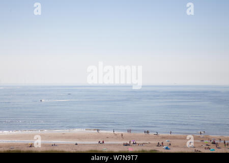 Egmond aan Zee, Netherlands - bathing people on the beach in the glistening sun (high key exposure) Stock Photo