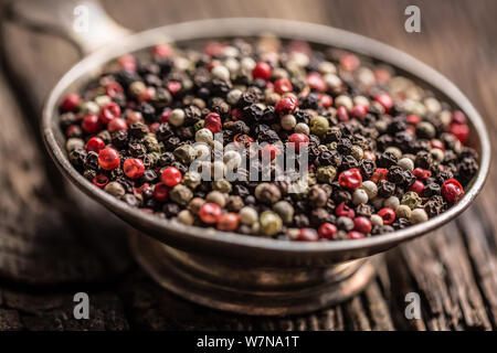 Mixed peppercorns red black and white in bowl - Close-up Stock Photo