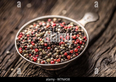 Mixed peppercorns red black and white in bowl - Close-up Stock Photo