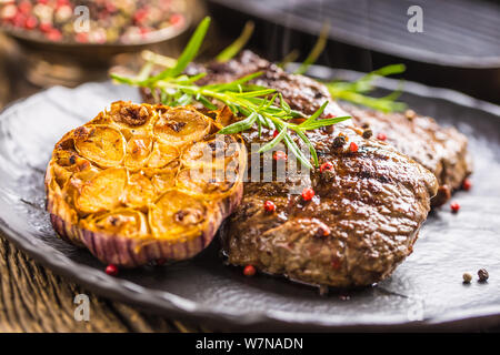 Grilled beef Rib Eye steak with garlic rosemary salt and spices Stock Photo