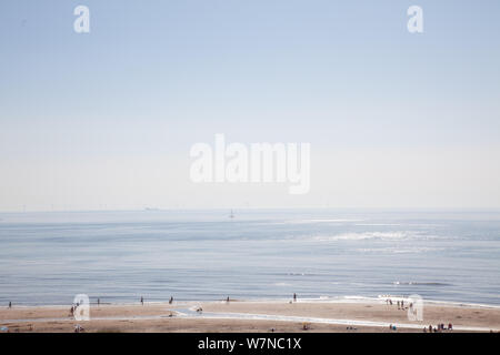 Egmond aan Zee, Netherlands - bathing people on the beach in the glistening sun (high key exposure) Stock Photo